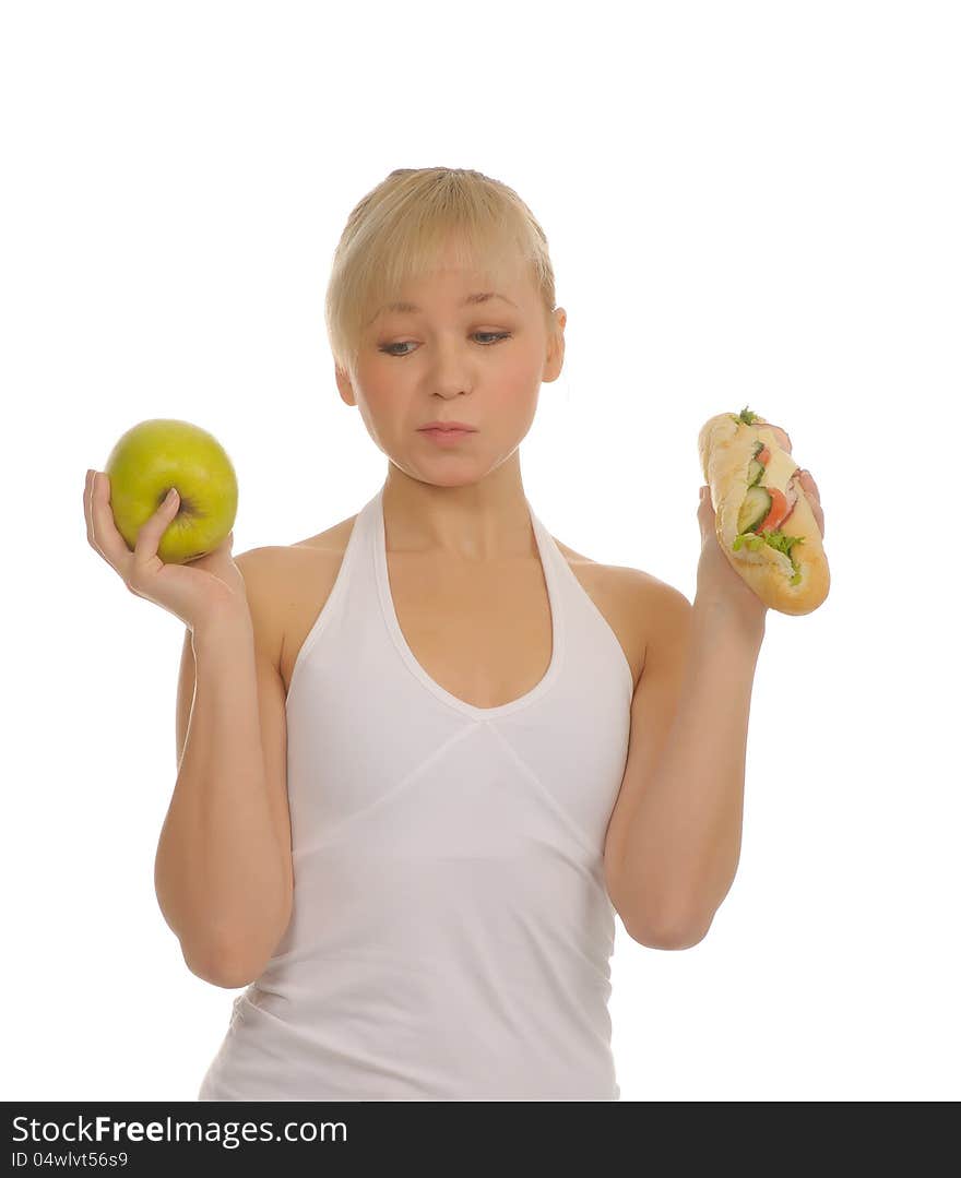 Slim woman choosing between apple and hamburger