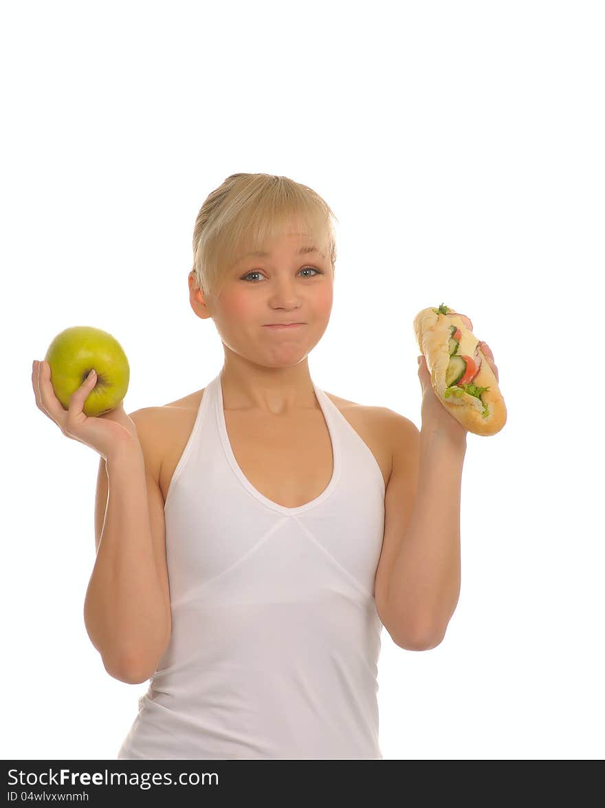 Slim woman choosing between apple and hamburger