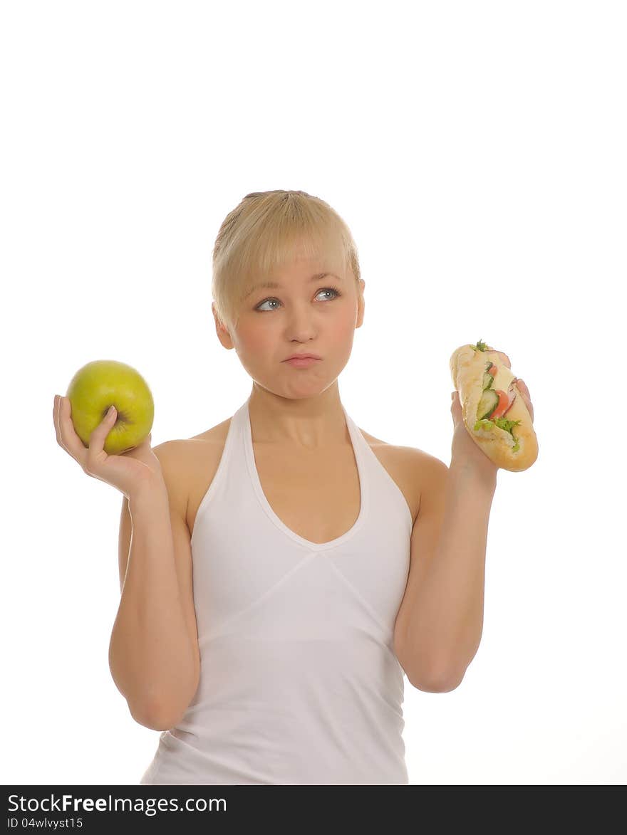 Slim woman choosing between apple and hamburger