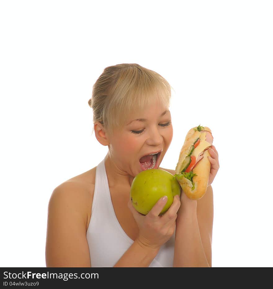 Slim woman choosing between apple and hamburger