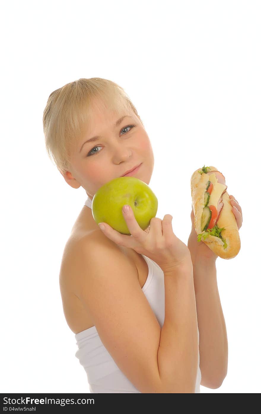 Slim woman choosing between apple and hamburger