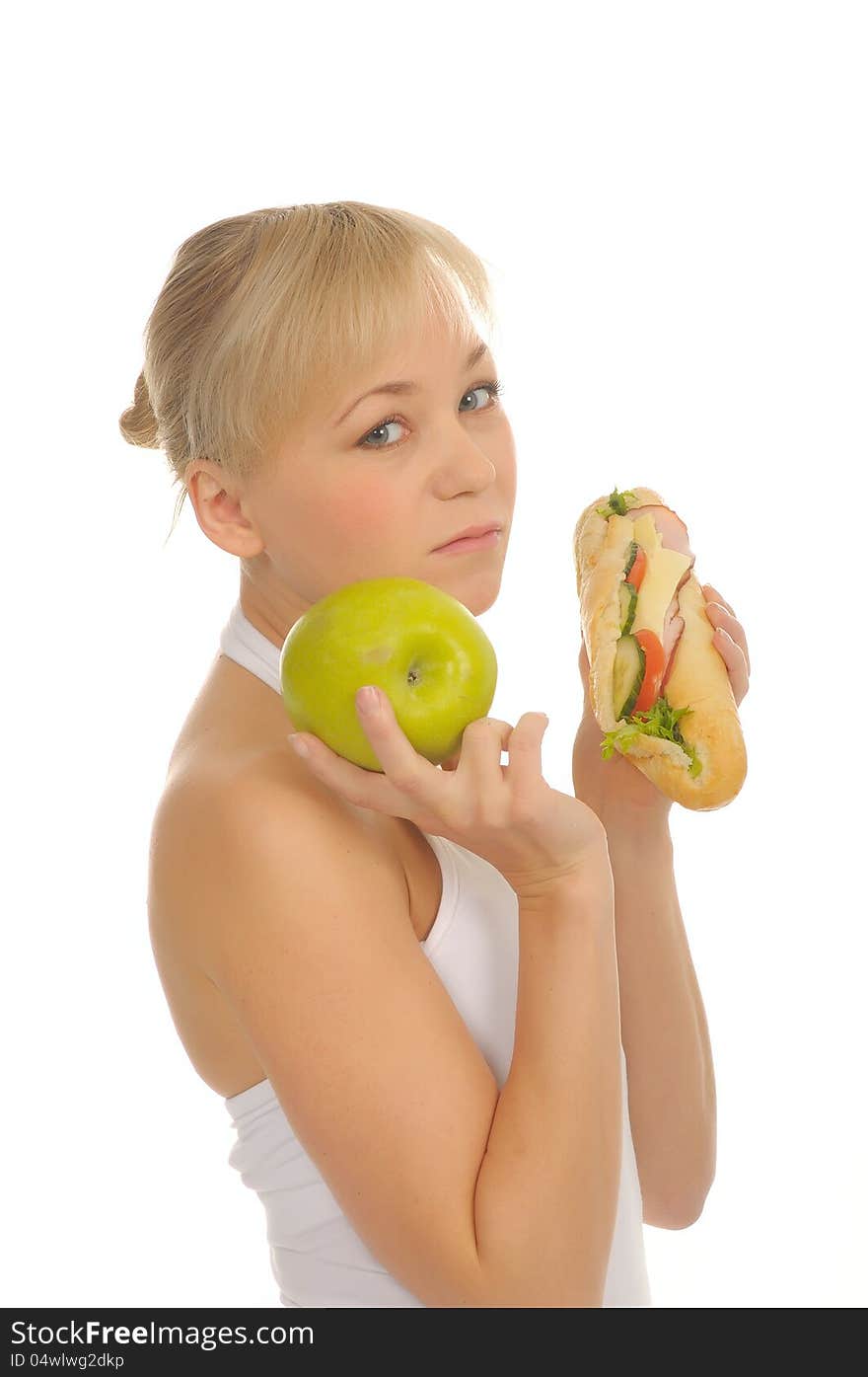 Slim woman choosing between apple and hamburger