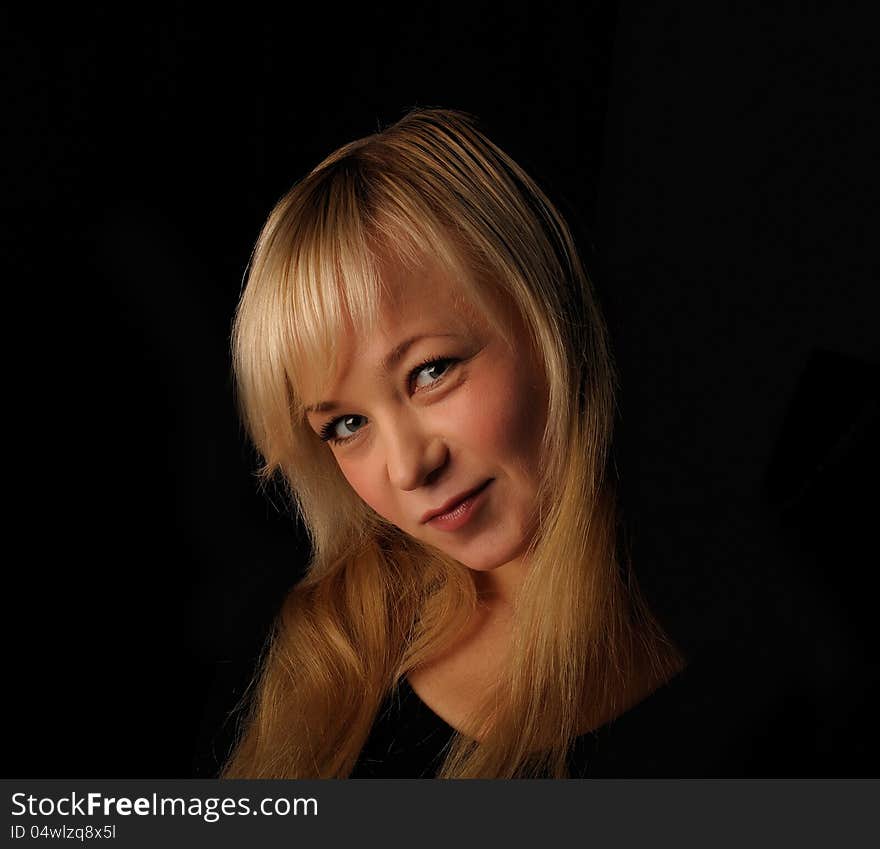 Young blond hair woman portrait   on dark background