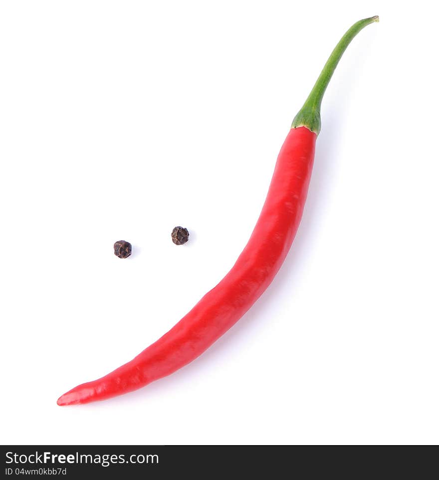 Red chili pepper forming a funny face with  smile on a white