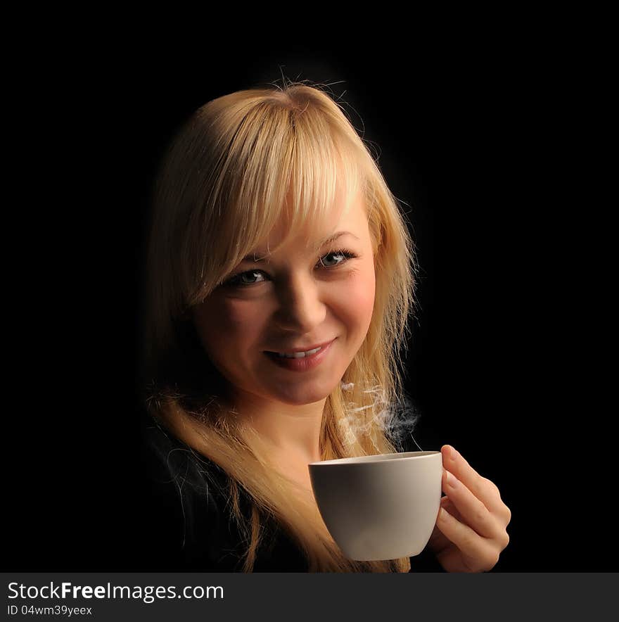 Young blond hair woman with coffee  on a dark background. Young blond hair woman with coffee  on a dark background.