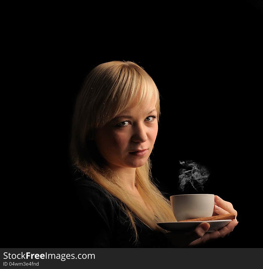 Young blond hair woman with coffee  on a dark background. Young blond hair woman with coffee  on a dark background.