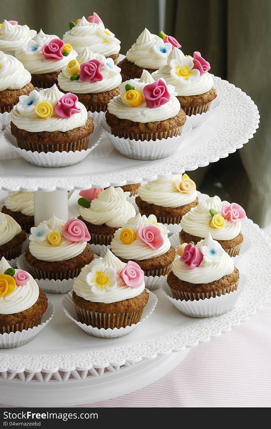 Carrot cupcakes decorated with colorful fondant flowers. Carrot cupcakes decorated with colorful fondant flowers