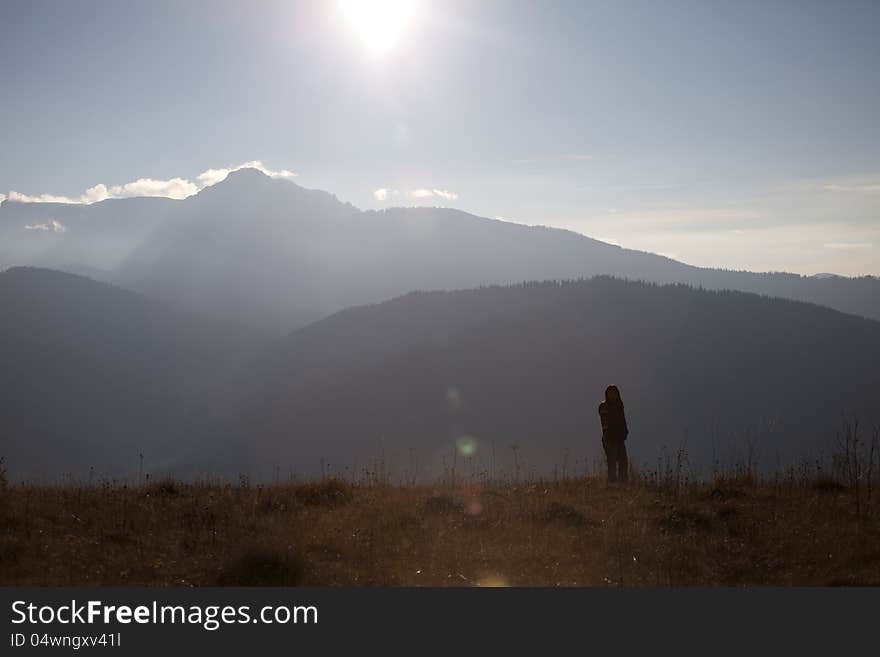 Tourist admiring sunlight on mountains range. Tourist admiring sunlight on mountains range