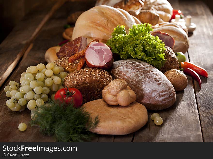 Healthy fruits and vegetables near bread on studio wood table. Healthy fruits and vegetables near bread on studio wood table