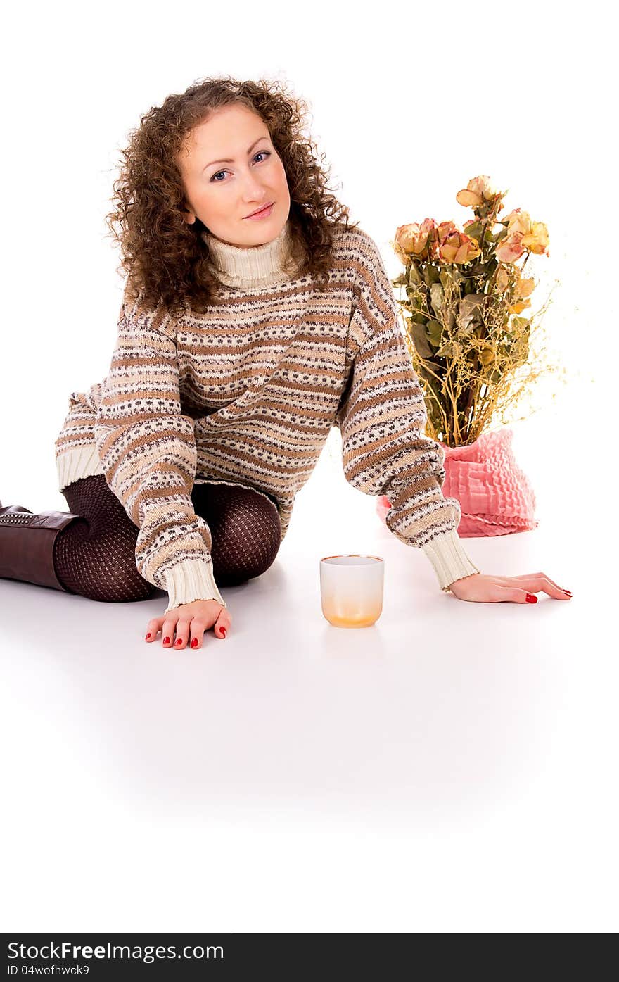 Girl in winter sweater resting isolated on white background