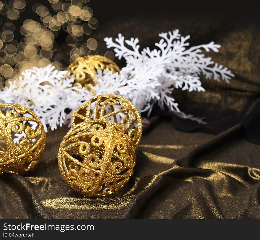 Golden Christmas balls on shiny fabric and white decoration branch. Golden Christmas balls on shiny fabric and white decoration branch