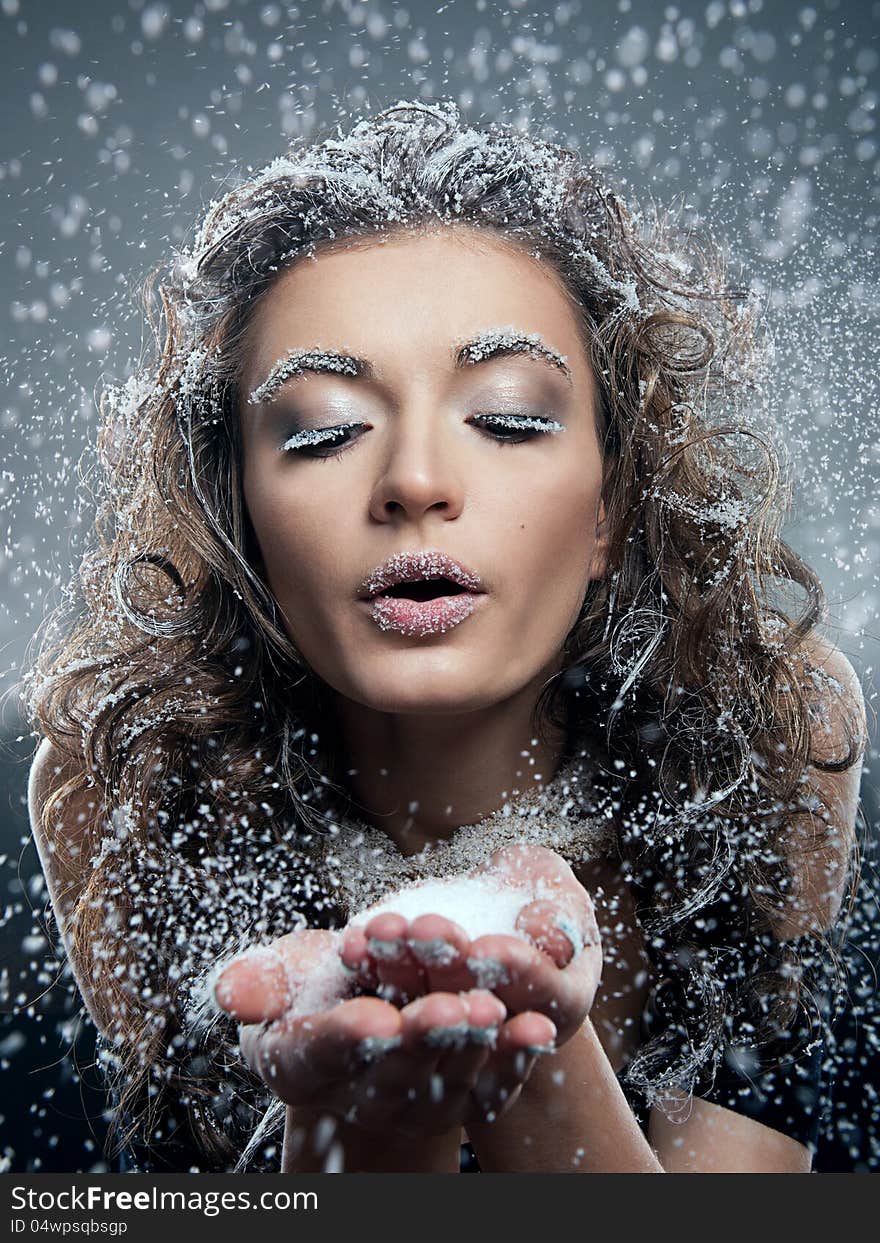 Portrait of young woman with snow make-up. Christmas snow queen