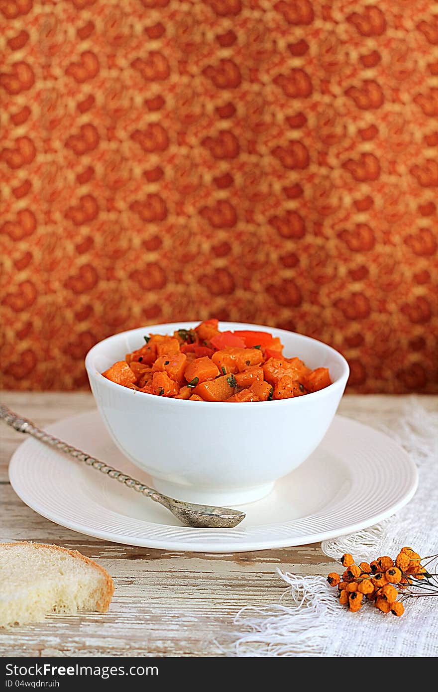 Pumpkin stew in a bowl on a wooden table. Pumpkin stew in a bowl on a wooden table.