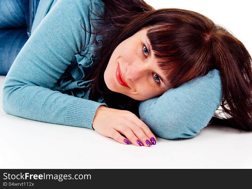 The girl poses while lying on the floor