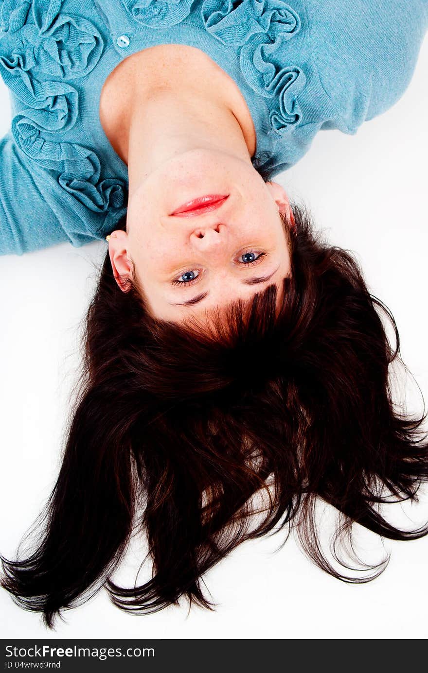 The girl poses while lying on the floor