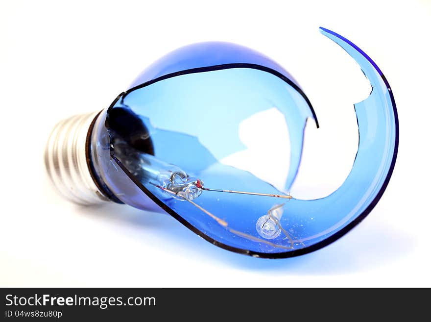 Broken blue light bulb on a white background. Broken blue light bulb on a white background