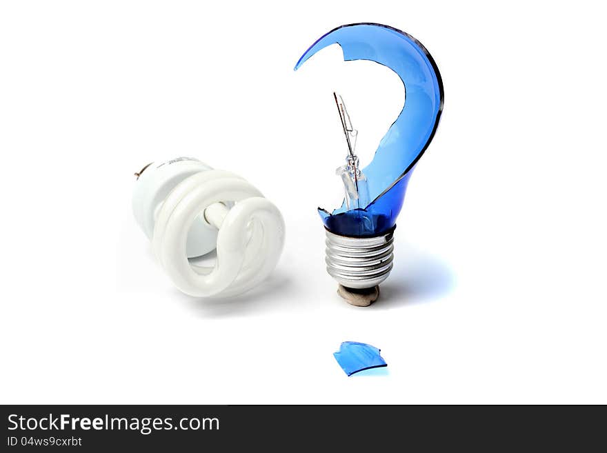 Broken light bulb in the form of a question mark next to a fluorescent bulb. Broken light bulb in the form of a question mark next to a fluorescent bulb