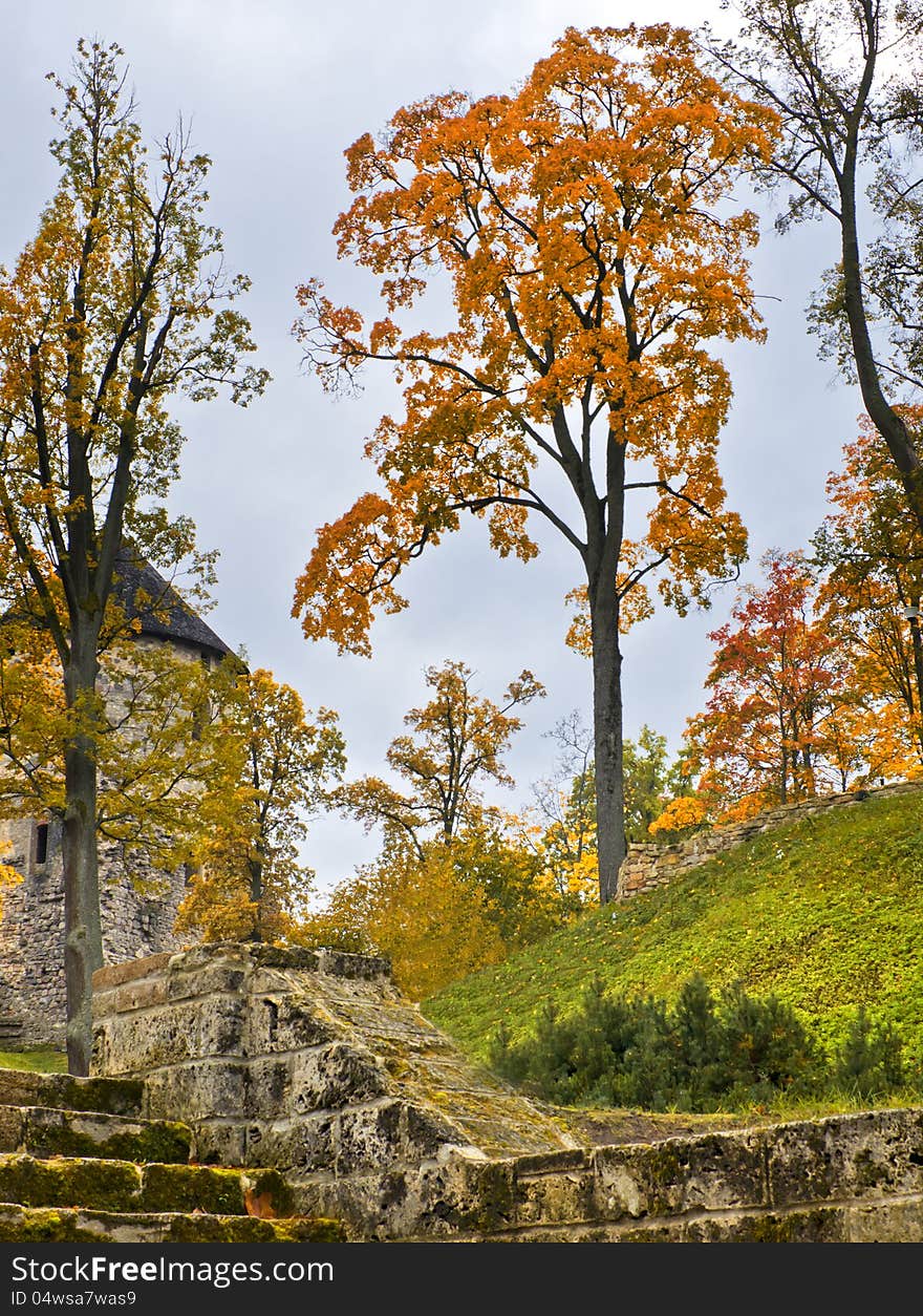 Ancient castle and  mossy stone stairs  in  colorful autumnal park , Cesis, Latvia, Europe. Ancient castle and  mossy stone stairs  in  colorful autumnal park , Cesis, Latvia, Europe