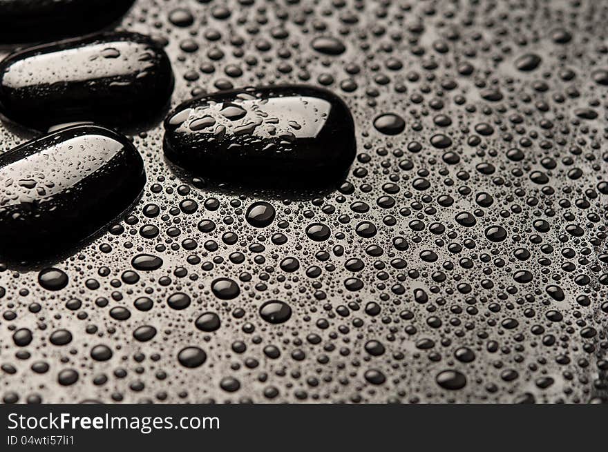 Abstract background. black stones and pebbles with water drops