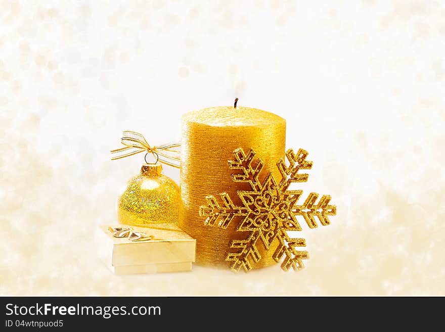 Winter holiday background with golden present gift box, candle ornament & Christmas snow decoration. Winter holiday background with golden present gift box, candle ornament & Christmas snow decoration