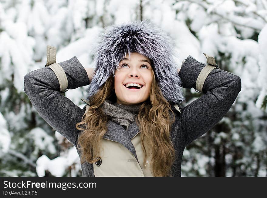 Smiling female in fure hat at the winter forest. Smiling female in fure hat at the winter forest