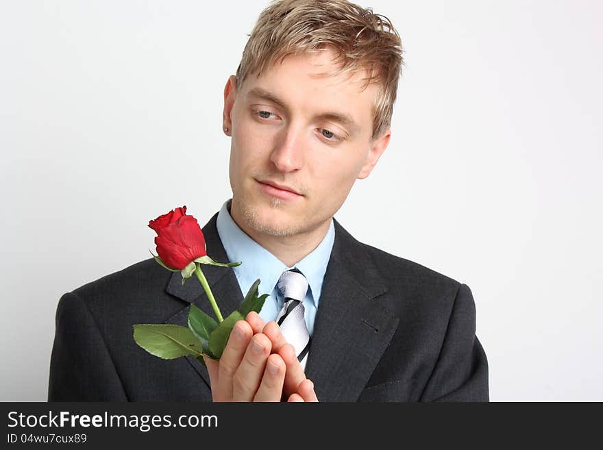 Portrait of a young man with a red rose. Portrait of a young man with a red rose