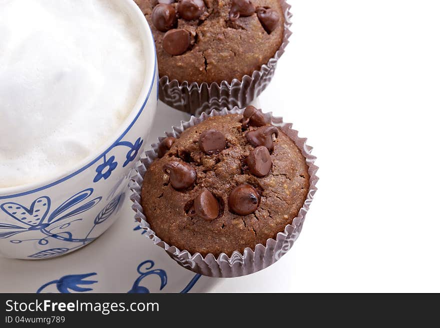 Fresh chocolate chip muffins with coffee cup, isolated on white background. Fresh chocolate chip muffins with coffee cup, isolated on white background