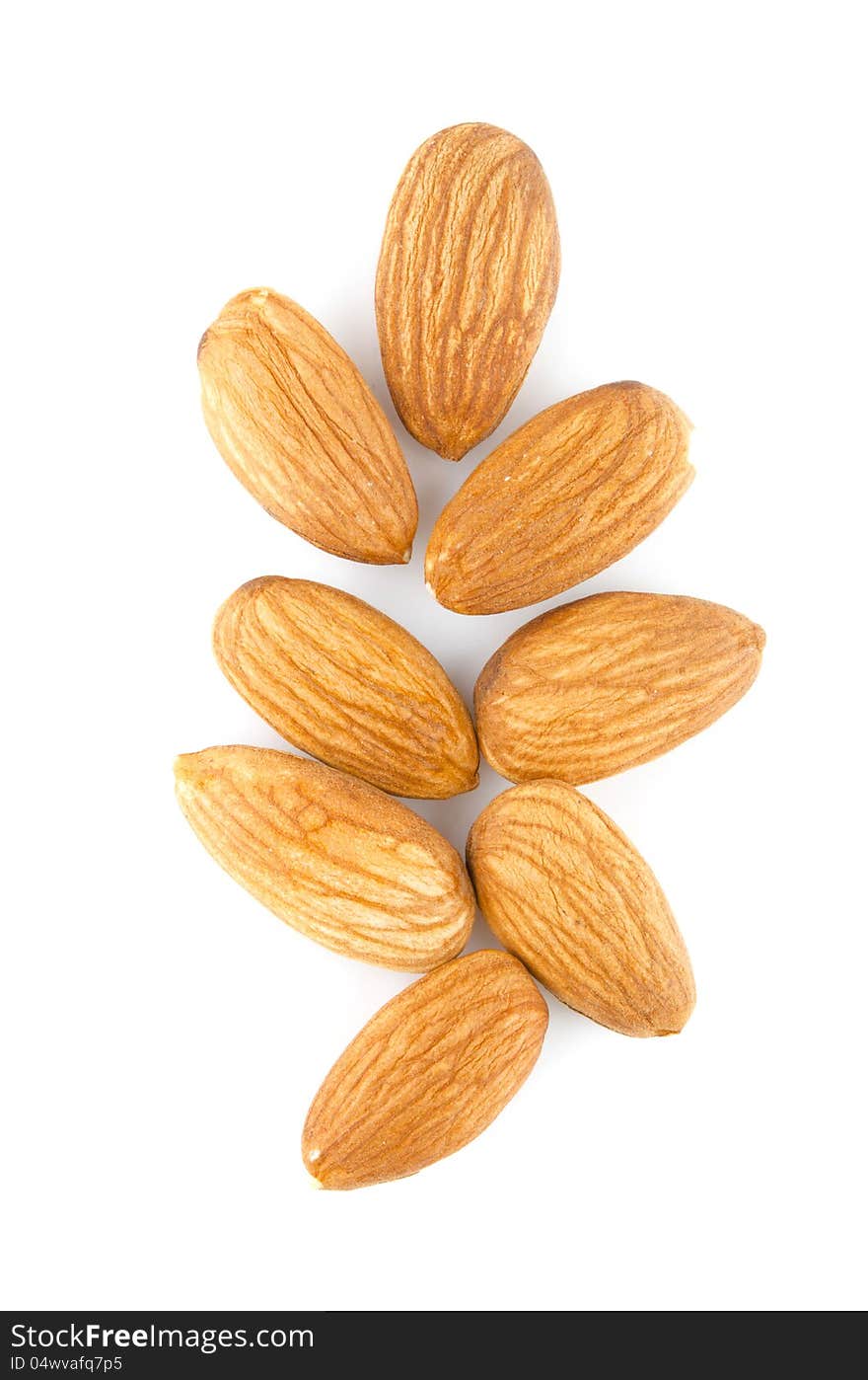 Few almonds on a white background isolated. Few almonds on a white background isolated