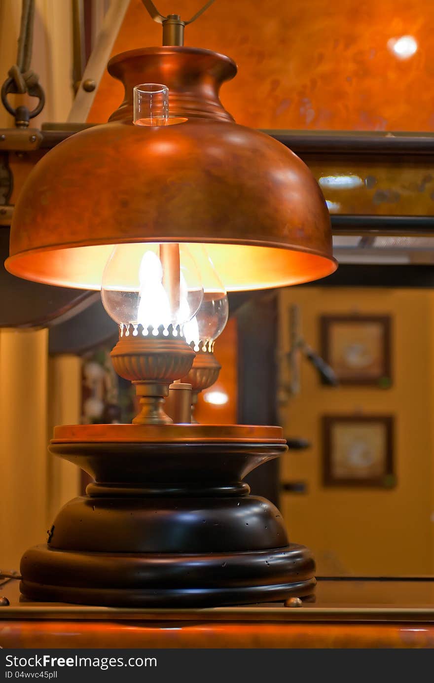 Old kerosene lamp with copper shade