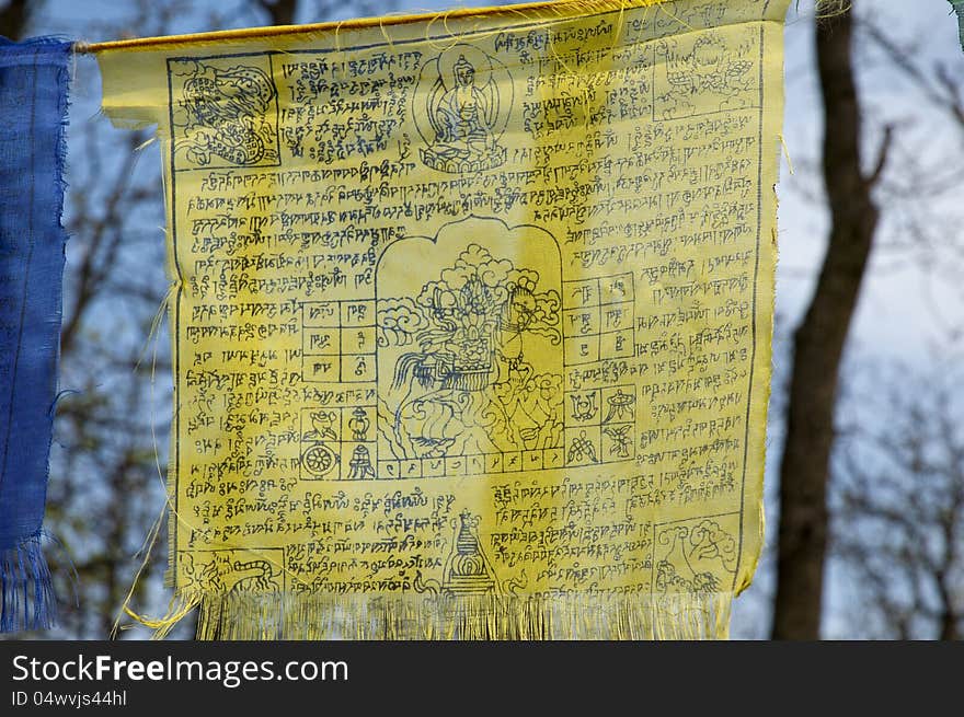 Tibetan prayer flags with ancient buddhism symbols and prayers written in sanskrit have been used in Buddhism for hundreds of years. Buddhists believe that they need to pray all the time, they tie colorful prayer flags which are flown to bring blessings and luck to the places they are flown. Tibetan prayer flags with ancient buddhism symbols and prayers written in sanskrit have been used in Buddhism for hundreds of years. Buddhists believe that they need to pray all the time, they tie colorful prayer flags which are flown to bring blessings and luck to the places they are flown.