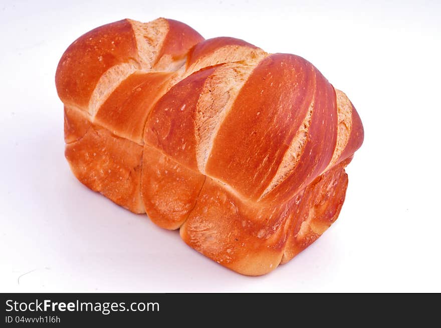 Loaf of white bread lies against a white background. Loaf of white bread lies against a white background