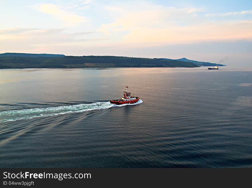 Pilot and cargo ship at the sunset, Mediterranean Sea. Pilot and cargo ship at the sunset, Mediterranean Sea