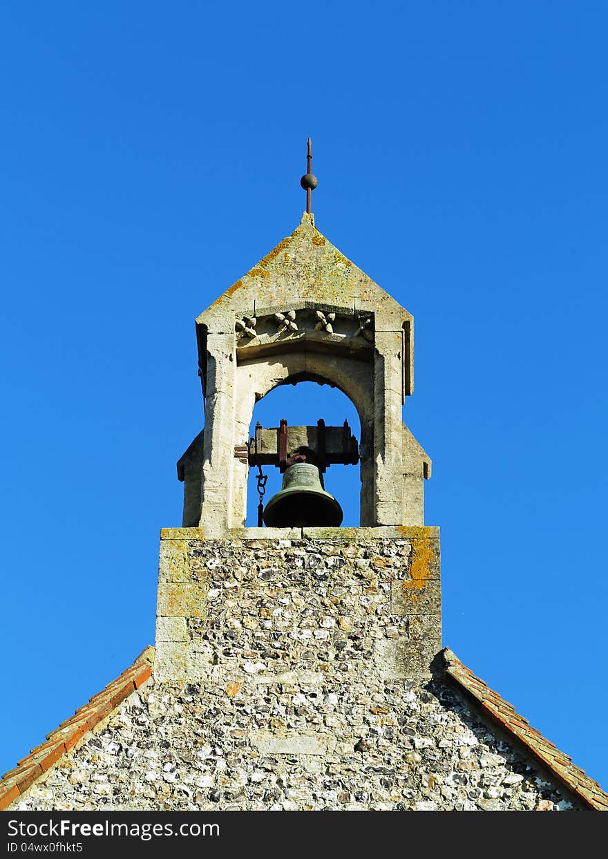 English Village Church Bell Tower against a Blue Sky. English Village Church Bell Tower against a Blue Sky