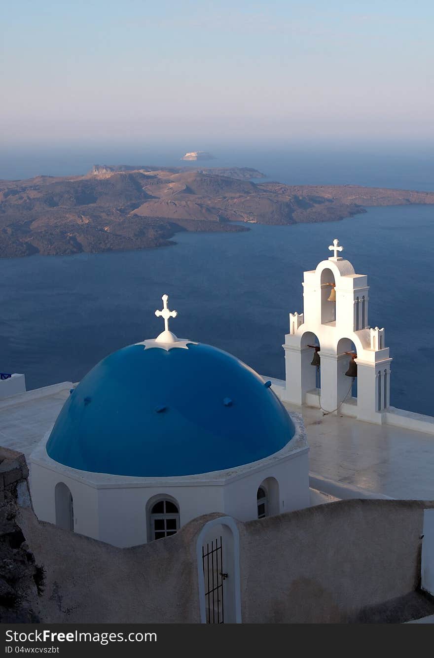 Church of the island of Santorini against the bright sky and sea