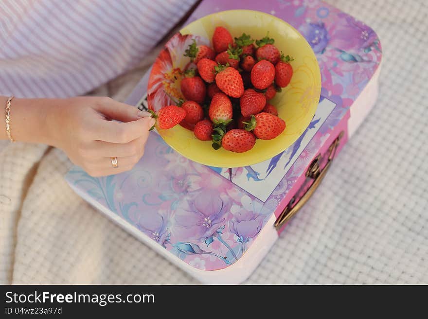 Red ripe strawberries lying on a yellow plate. Red ripe strawberries lying on a yellow plate