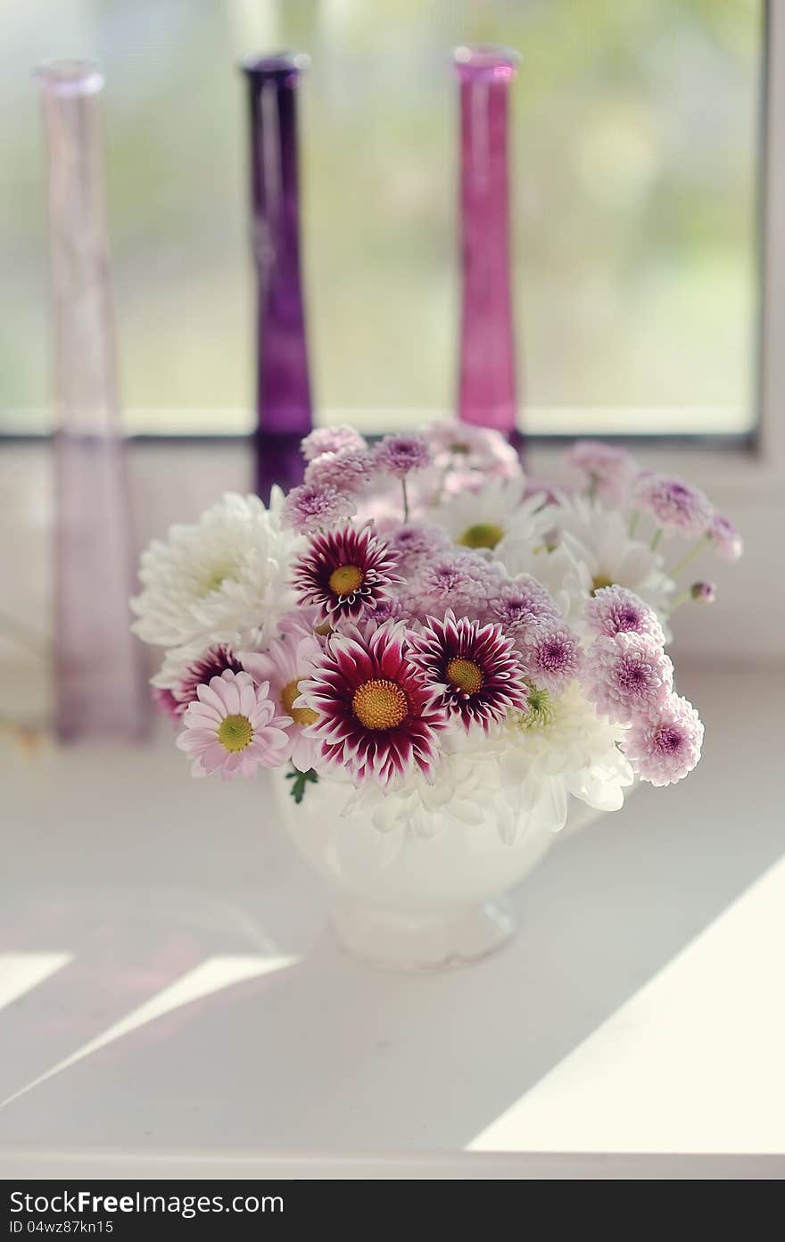 Beautiful delicate bouquet of pink chrysanthemums in a blue bucket. Beautiful delicate bouquet of pink chrysanthemums in a blue bucket