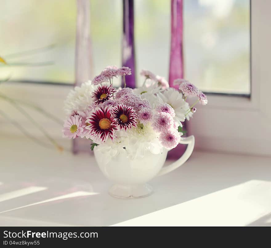 Beautiful delicate bouquet of pink chrysanthemums in a blue bucket. Beautiful delicate bouquet of pink chrysanthemums in a blue bucket