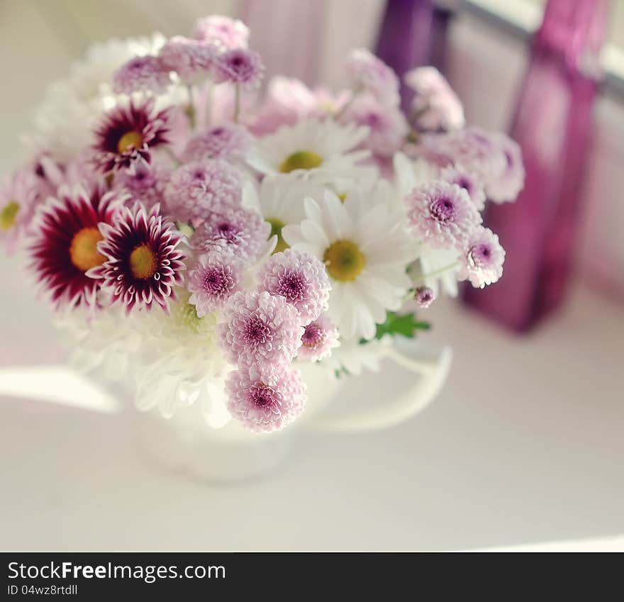 Beautiful delicate bouquet of pink chrysanthemums in a blue bucket. Beautiful delicate bouquet of pink chrysanthemums in a blue bucket