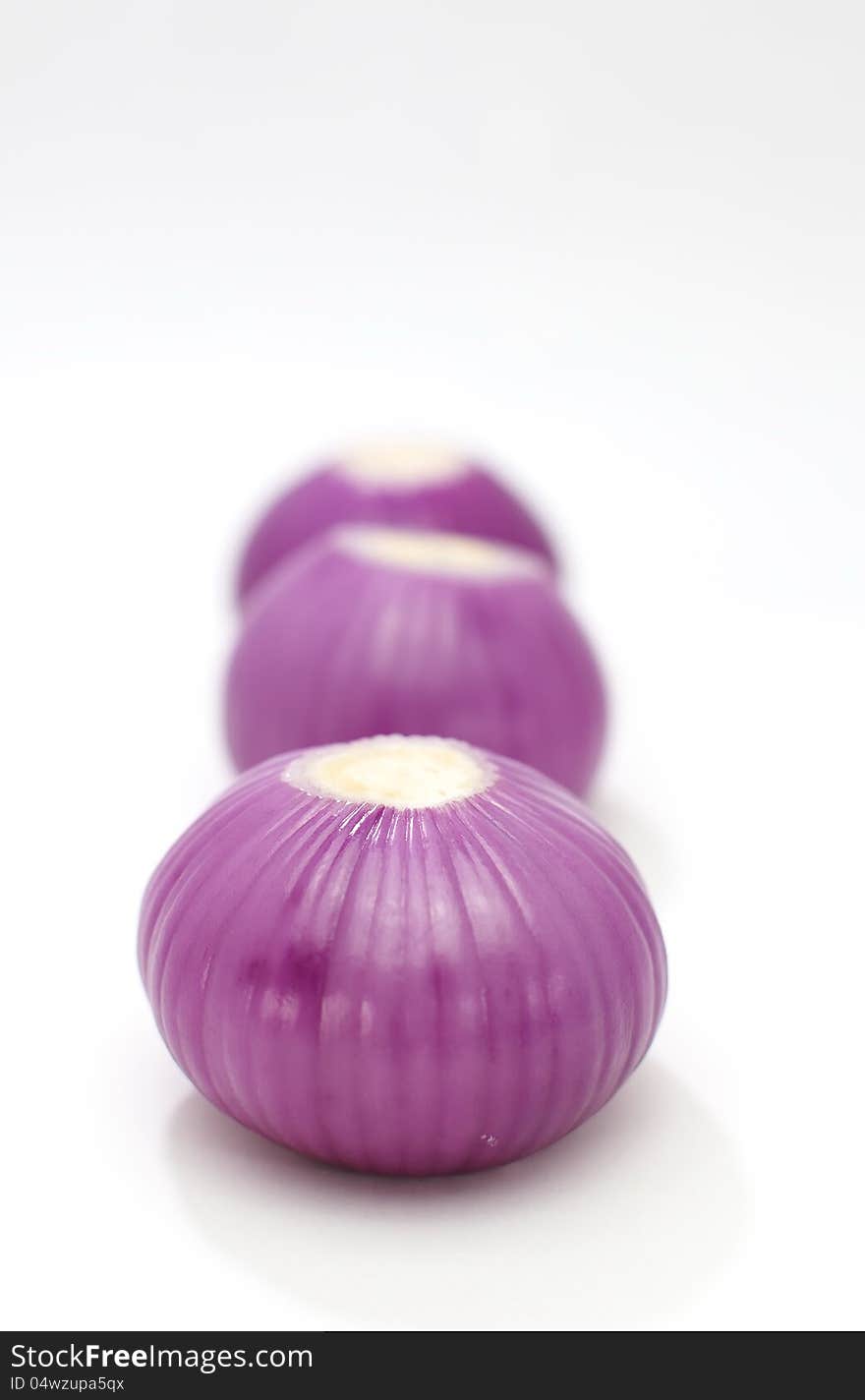 Red onion closeup on white background