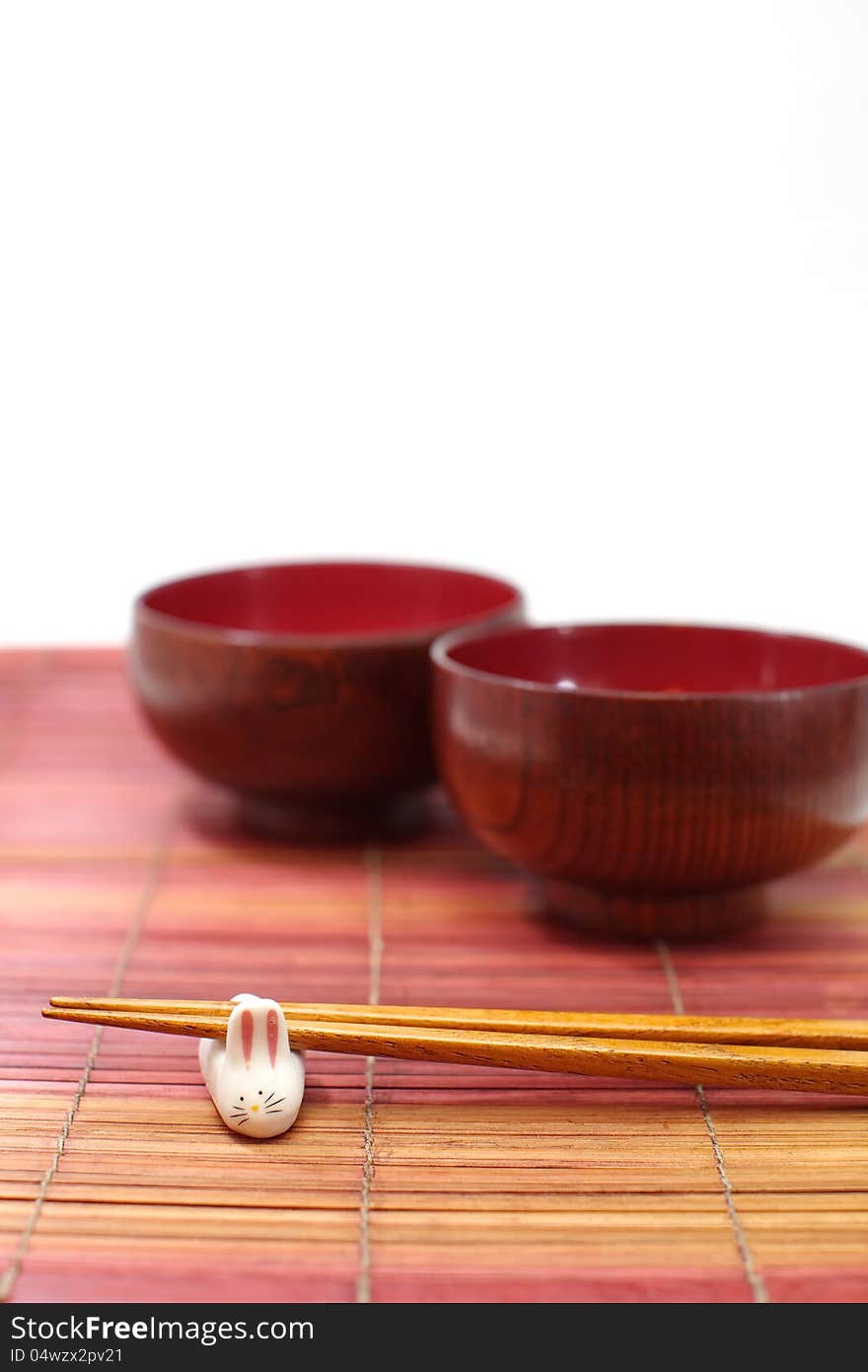 Chopsticks in asian set table on white background