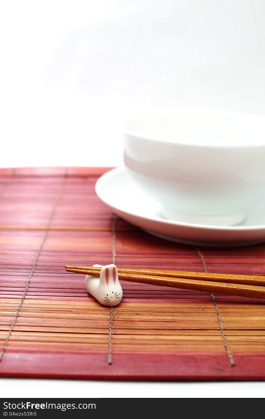 Chopsticks in asian set table on white background