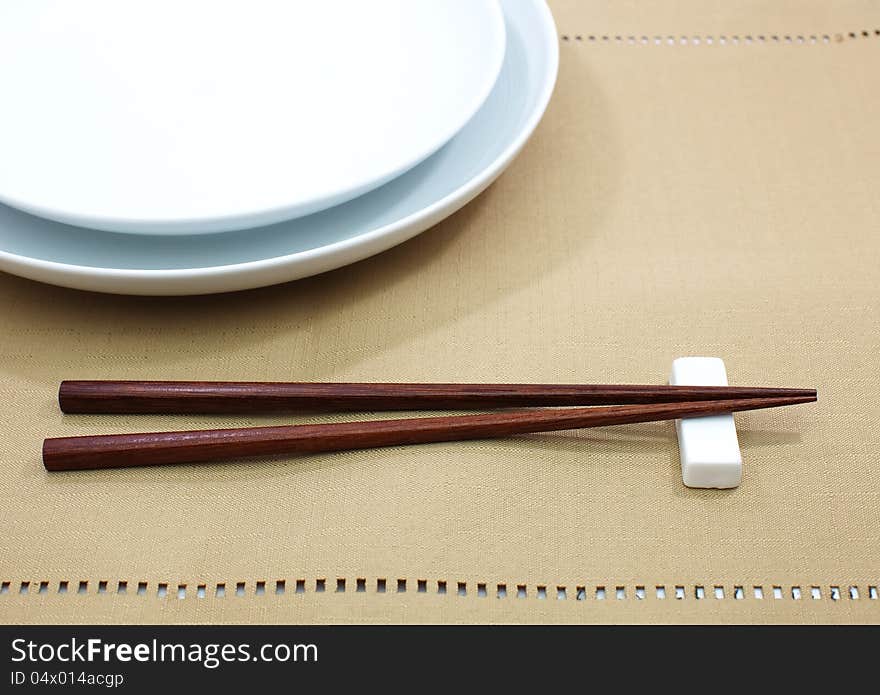 Chopsticks in asian set table on white background