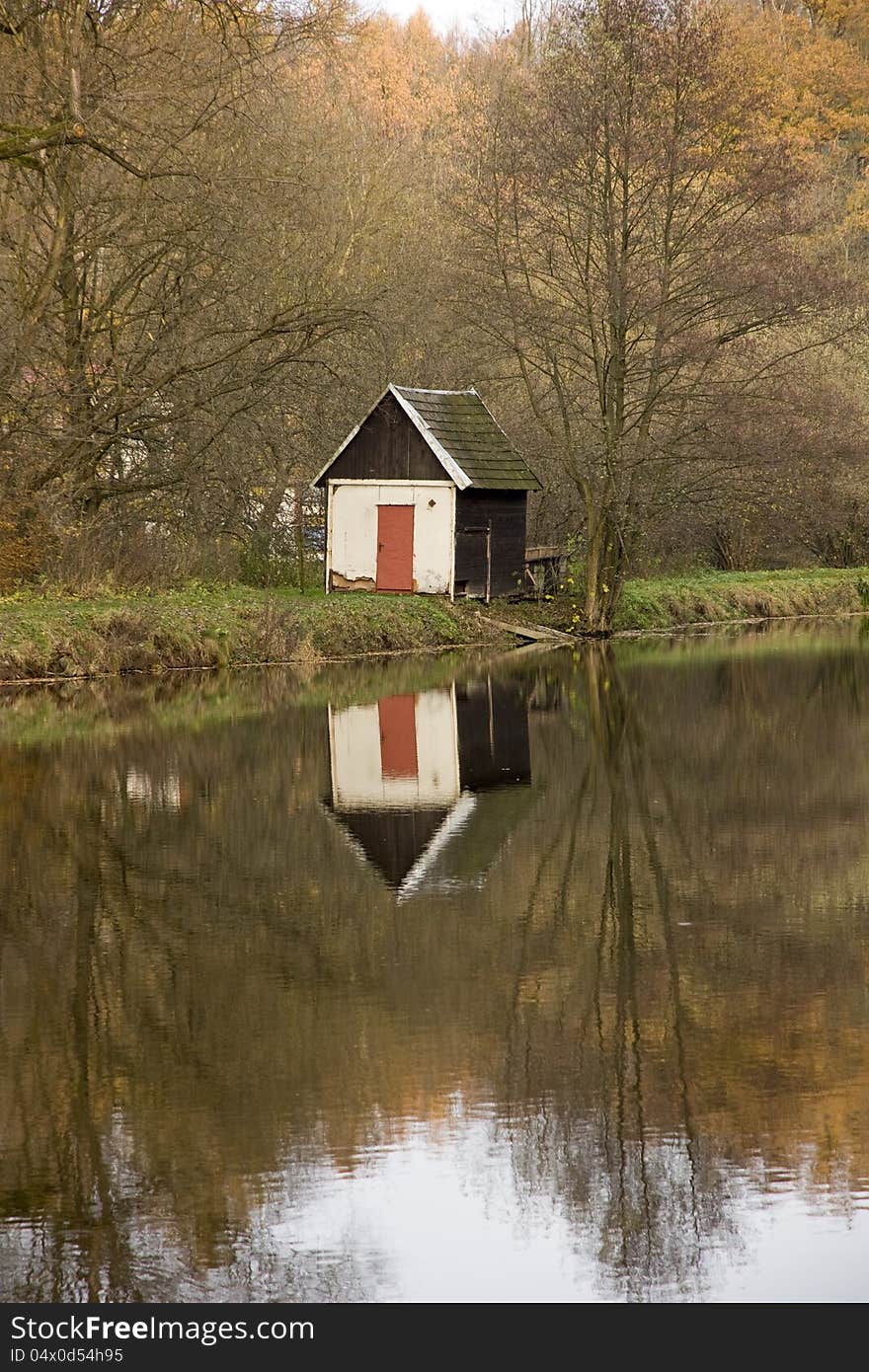 House reflecting on water in autumn, nove mesto nad metuji