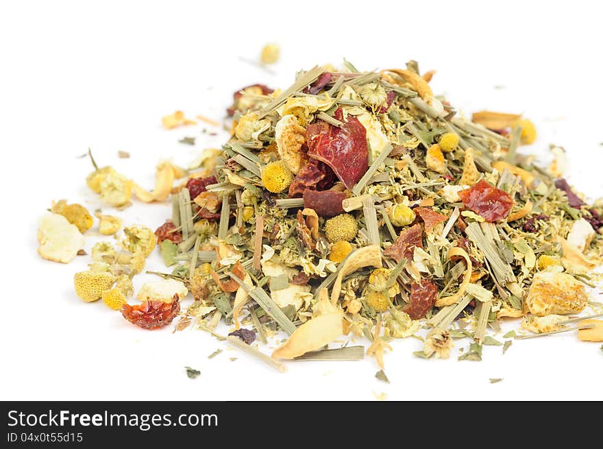 A pile of herbal tea with chamomile, lemongrass and citrus peels on a white background. A pile of herbal tea with chamomile, lemongrass and citrus peels on a white background