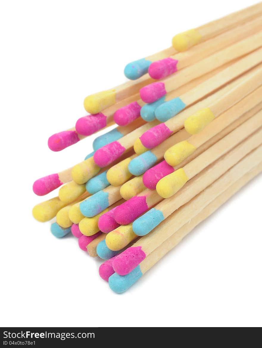 A bunch of multicolored matches on a white background. A bunch of multicolored matches on a white background