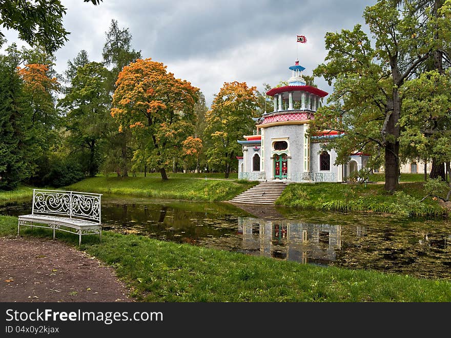 Chinese pagoda pavilion next to the autumn pond in the park. Chinese pagoda pavilion next to the autumn pond in the park