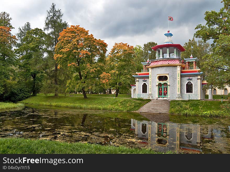 Chinese pagoda pavilion next to the autumn pond in the park. Chinese pagoda pavilion next to the autumn pond in the park