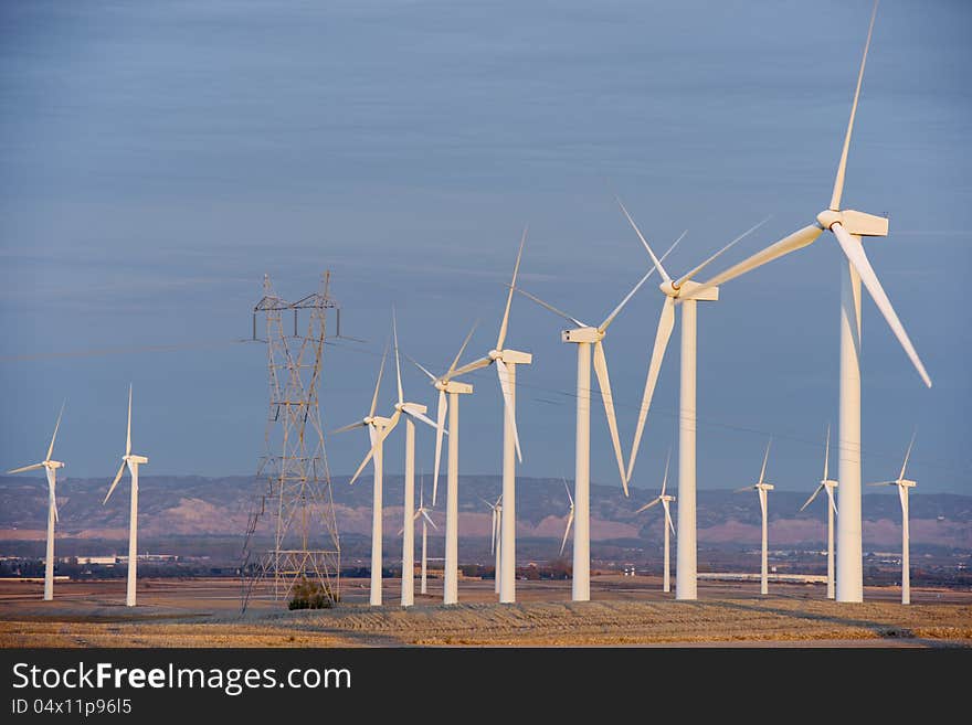 Aligned windmills for renowable electric production and power line, Pozuelo de Aragon, Zaragoza, Aragon, Spain