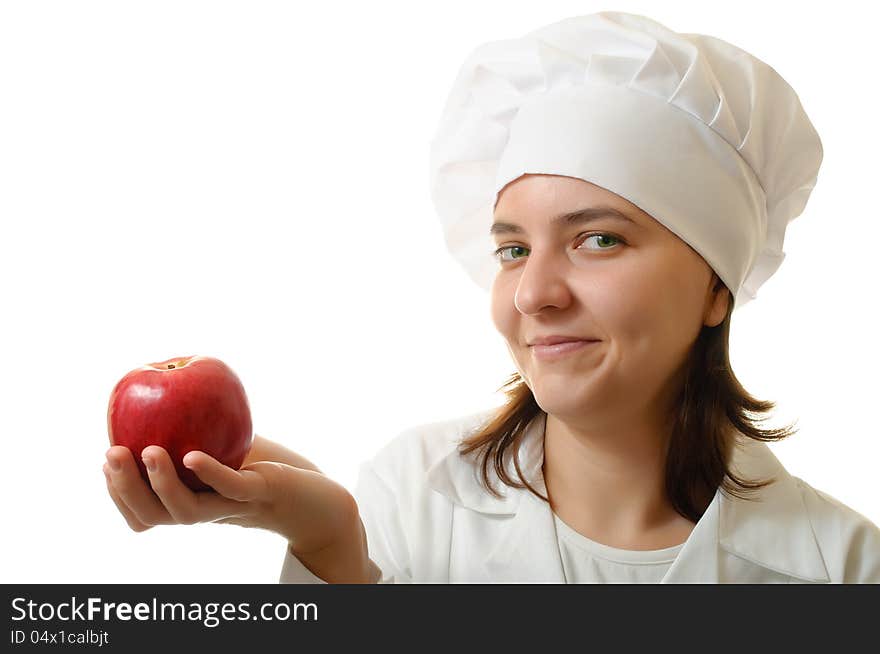 Happy cook woman holding an apple on white background. Happy cook woman holding an apple on white background