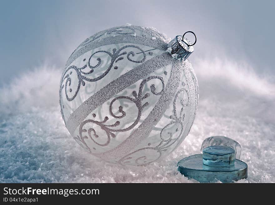 Lacy white ball for Christmas tree in the snow. Lacy white ball for Christmas tree in the snow.